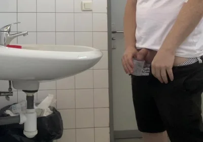 Guy Taking a Urine Sample in Hospital Toilets