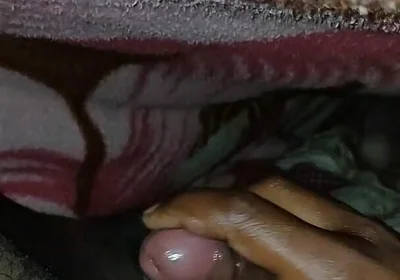Big Boss massaging penis oil under the blanket
