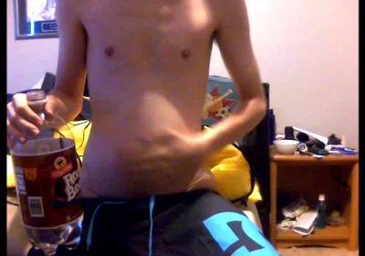 Young Guy Fills His Stomach with Water