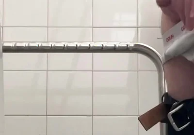 In the Hospital Toilets, a Guy Pisses Into a Cup for a Urine Sample, Then Gets Horny, Jerks-off and Cums