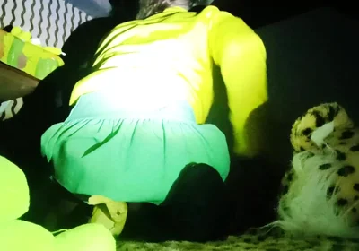 A Young Woman in a Skirt Spreads Her Buttocks Wide.