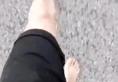 Jon Arteen Walks Barefoot on the Street Outdoors, the Boy Is Barefoot in the Crowded Tram to the Town Center