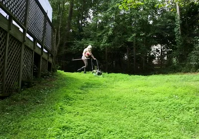 Big Fake Tits Crossdresser in Daisy Dukes Mowing Grass