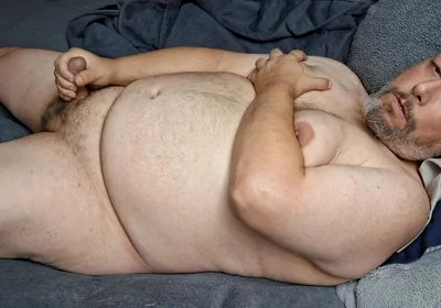Chubby Guy Lays in Bed and Cums