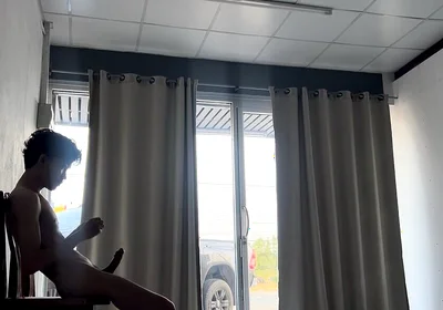 A Handsome Young Man Jerks off in Front of a Glass Door