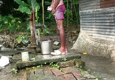 Black mature man bath in desi style. Showing big dick.
