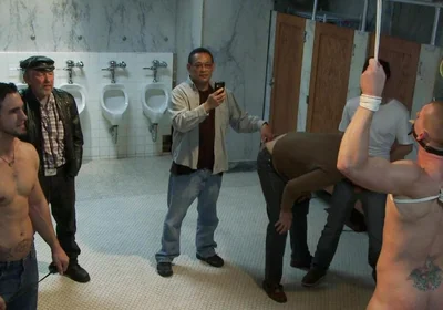 The Wrestler Gets Gang Banged by a Horny Crowd in a Public Restroom for Losing His Match.
