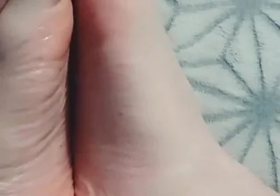 Guy Gently Massages His Feet with Oil